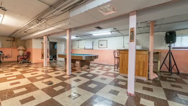 a view of a hall with wooden floor and a rug