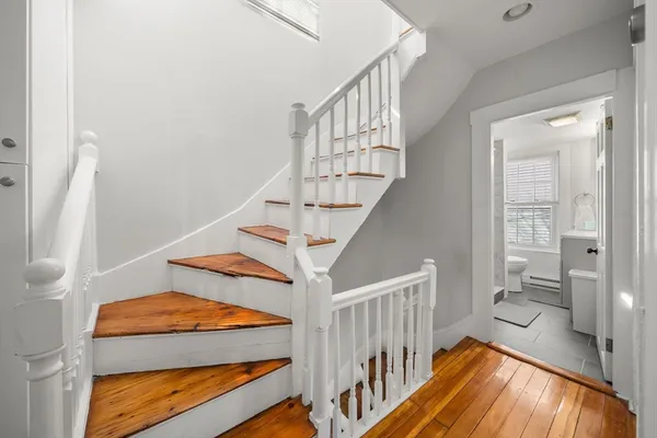 a view of entryway bedroom and hall with wooden floor
