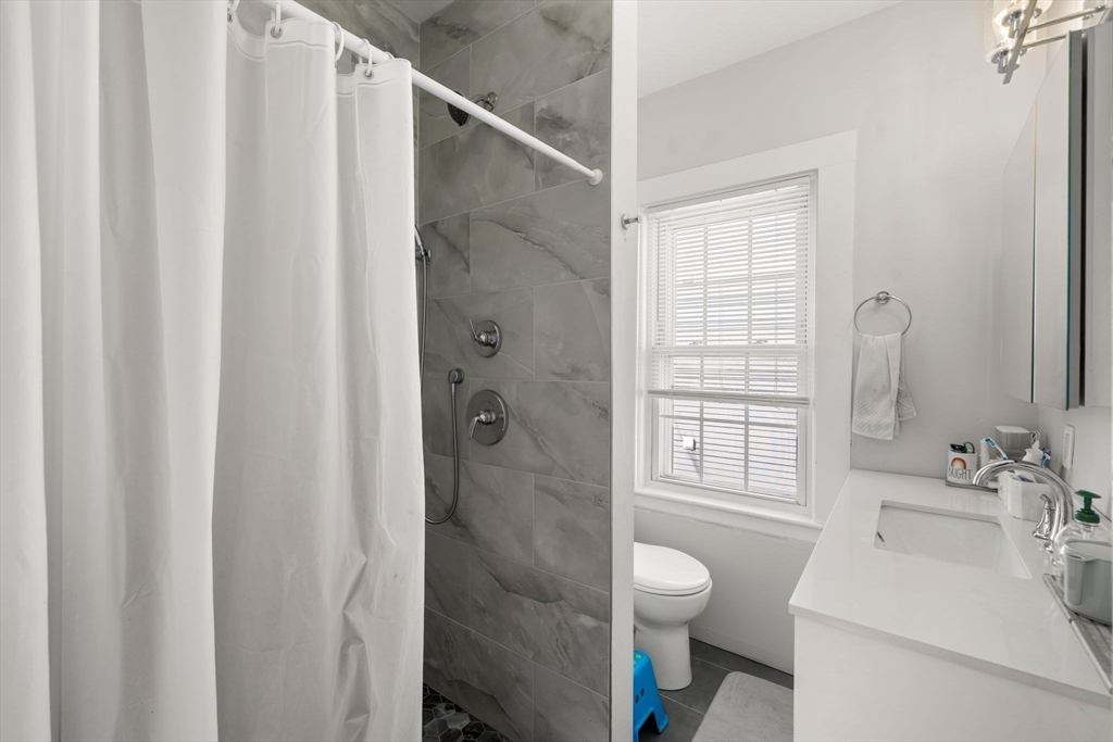 110 D Street Boston, MA 02127 - Photo 14 of 33 a bathroom with a sink toilet and shower