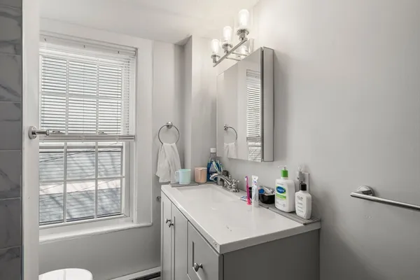 a bathroom with a sink vanity and a mirror