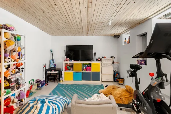 a bedroom with furniture and a flat screen tv