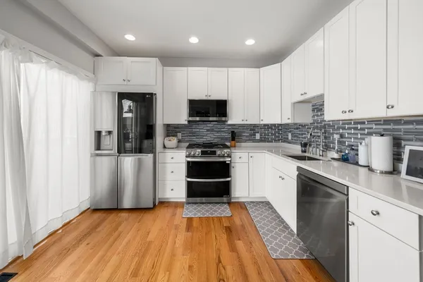 a kitchen with granite countertop stainless steel appliances and wooden cabinets
