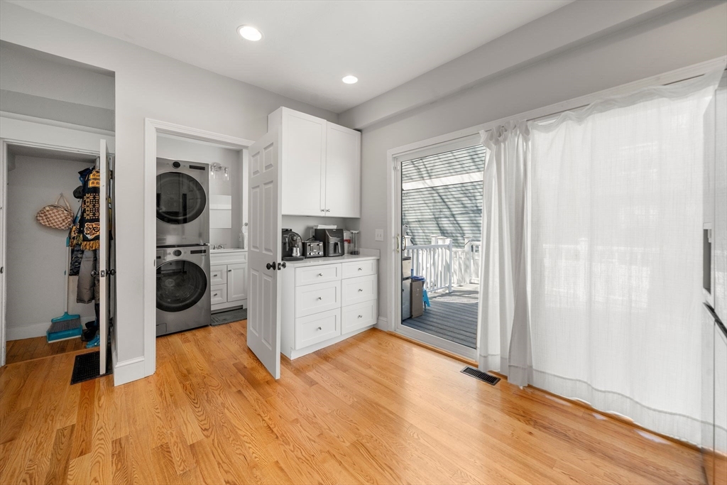 110 D Street Boston, MA 02127 - Photo 4 of 33 a view of a kitchen with refrigerator and wooden floor