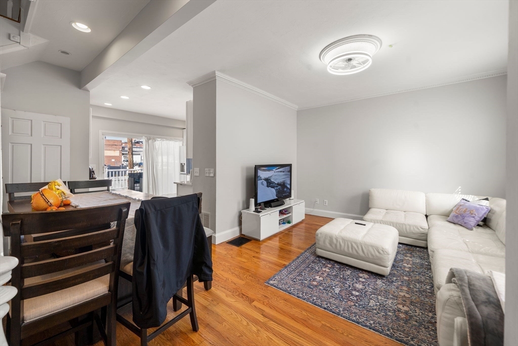 110 D Street Boston, MA 02127 - Photo 7 of 33 a living room with furniture and a flat screen tv