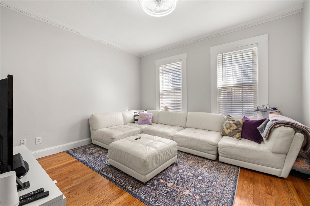 110 D Street Boston, MA 02127 - Photo 9 of 33 a living room with furniture and wooden floor