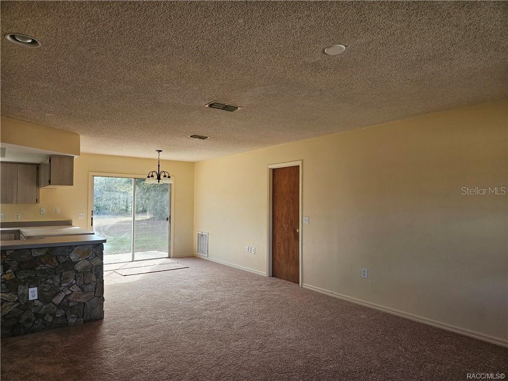 7370 West 7 Rivers Drive Crystal River, FL 34429 - Photo 3 of 22 a view of a kitchen with refrigerator and cabinets
