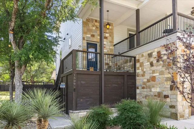 a kitchen with stainless steel appliances granite countertop a stove a sink dishwasher a refrigerator and white cabinets with wooden floor