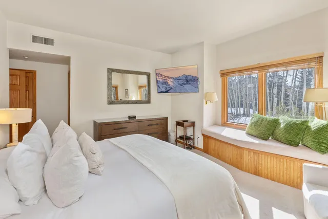 a bedroom with a large bed and a large window