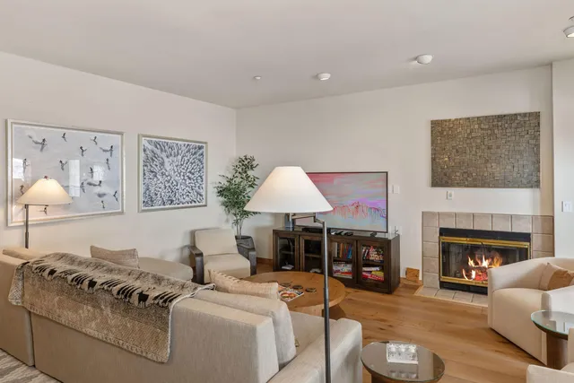 a living room with furniture a fireplace and a table