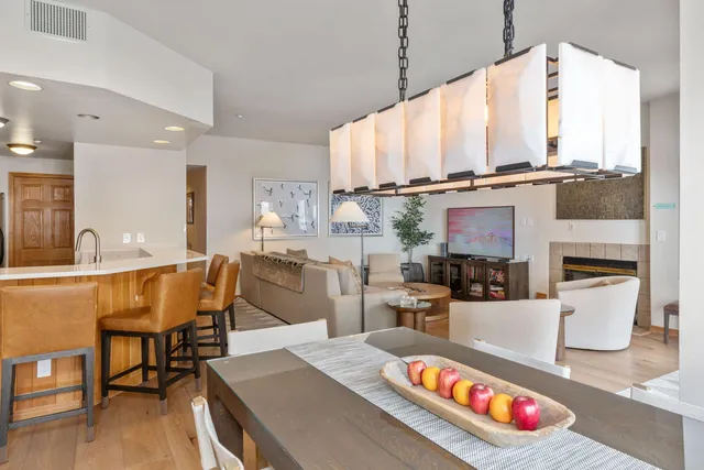 a living room with furniture a flat screen tv and kitchen view