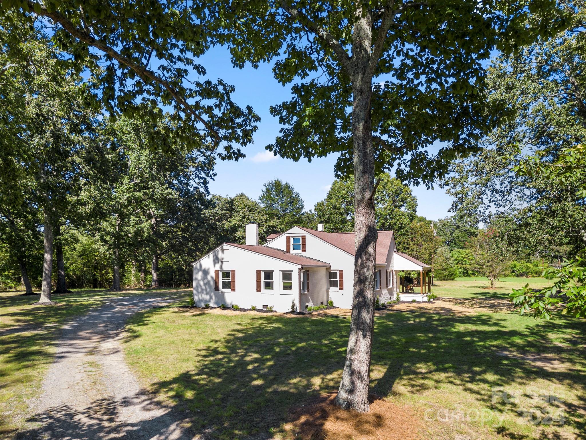 914 Margrace Road Kings Mountain, NC 28086 - Photo 36 of 36 a roof deck with table and chairs under an umbrella