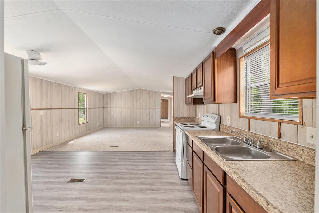 8535 Southwest 155th Street Dunnellon, FL 34432 - Photo 12 of 35 a kitchen with a sink stove and cabinets