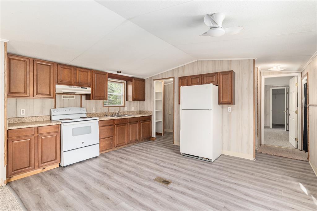 8535 Southwest 155th Street Dunnellon, FL 34432 - Photo 14 of 35 a kitchen with a refrigerator stove top oven and cabinets