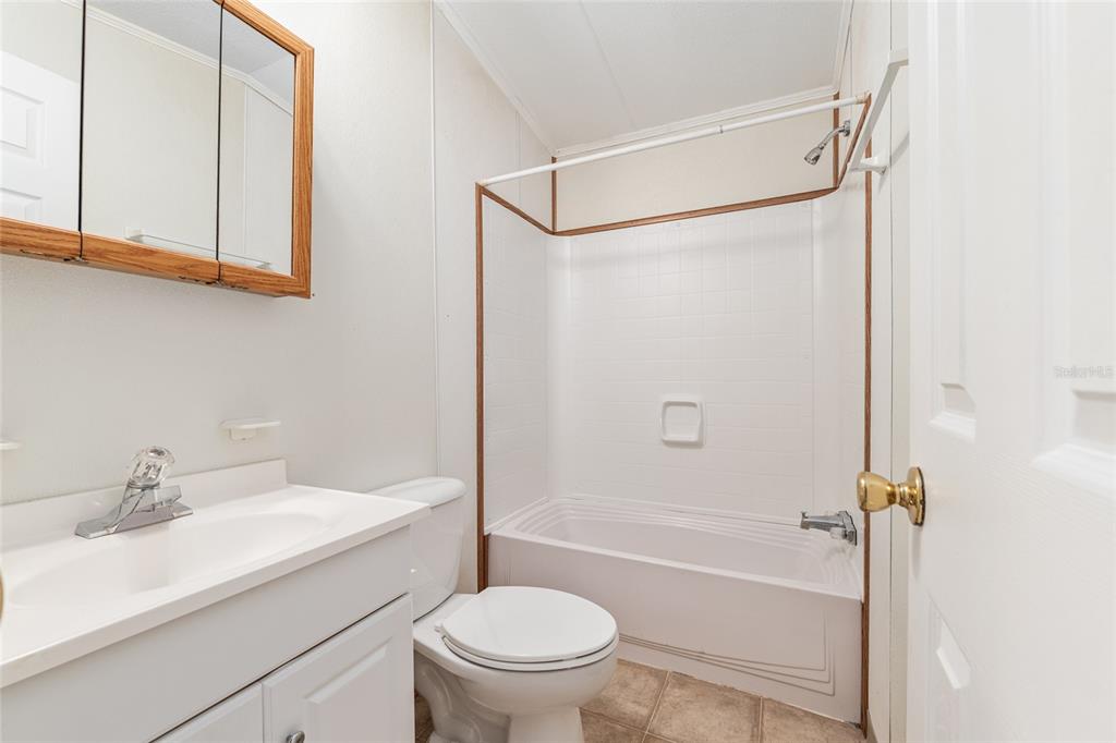 8535 Southwest 155th Street Dunnellon, FL 34432 - Photo 22 of 35 a bathroom with a sink a mirror toilet and bathtub