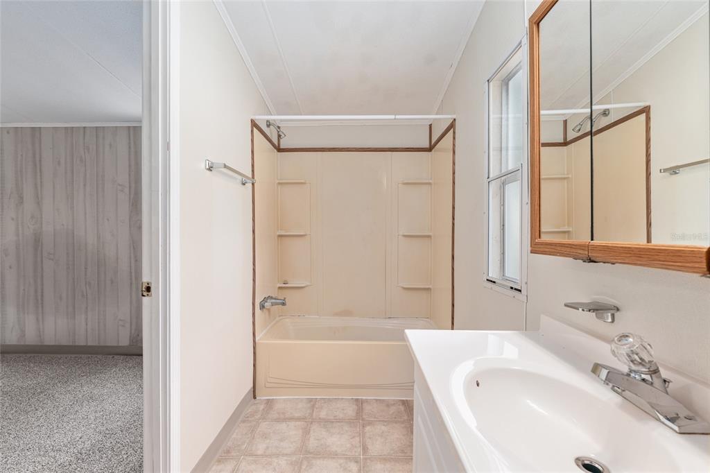 8535 Southwest 155th Street Dunnellon, FL 34432 - Photo 23 of 35 a bathroom with a tub shower sink and a mirror