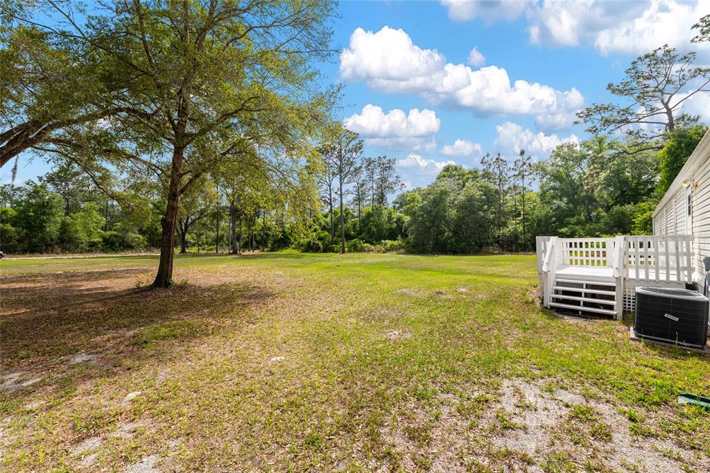 8535 Southwest 155th Street Dunnellon, FL 34432 - Photo 30 of 35 a view of a green field with wooden fence