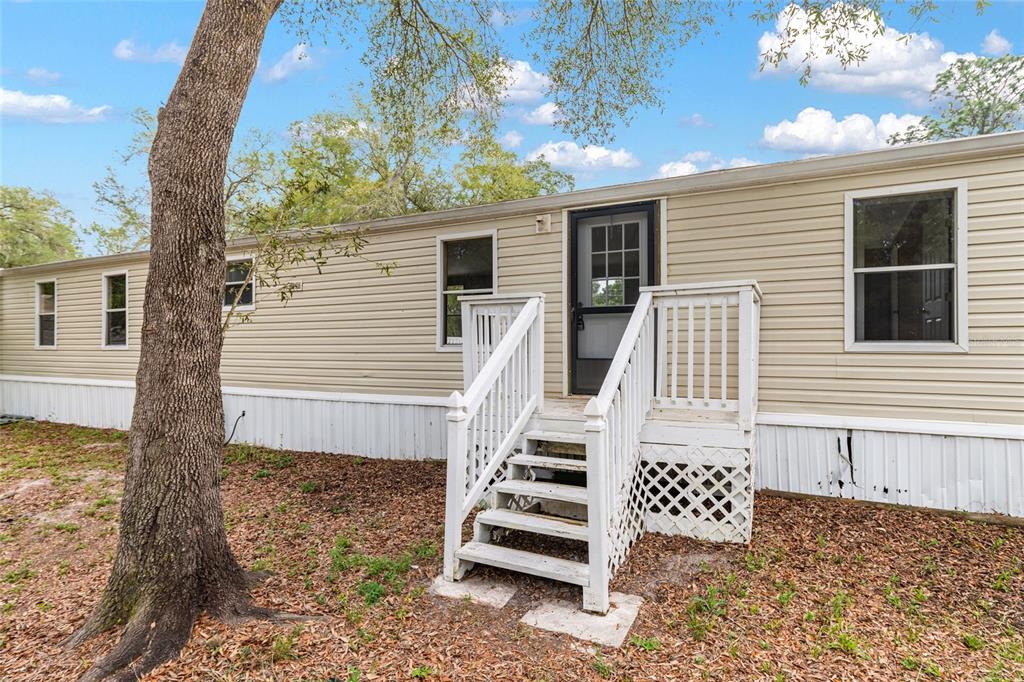 8535 Southwest 155th Street Dunnellon, FL 34432 - Photo 34 of 35 a view of a house with backyard and deck