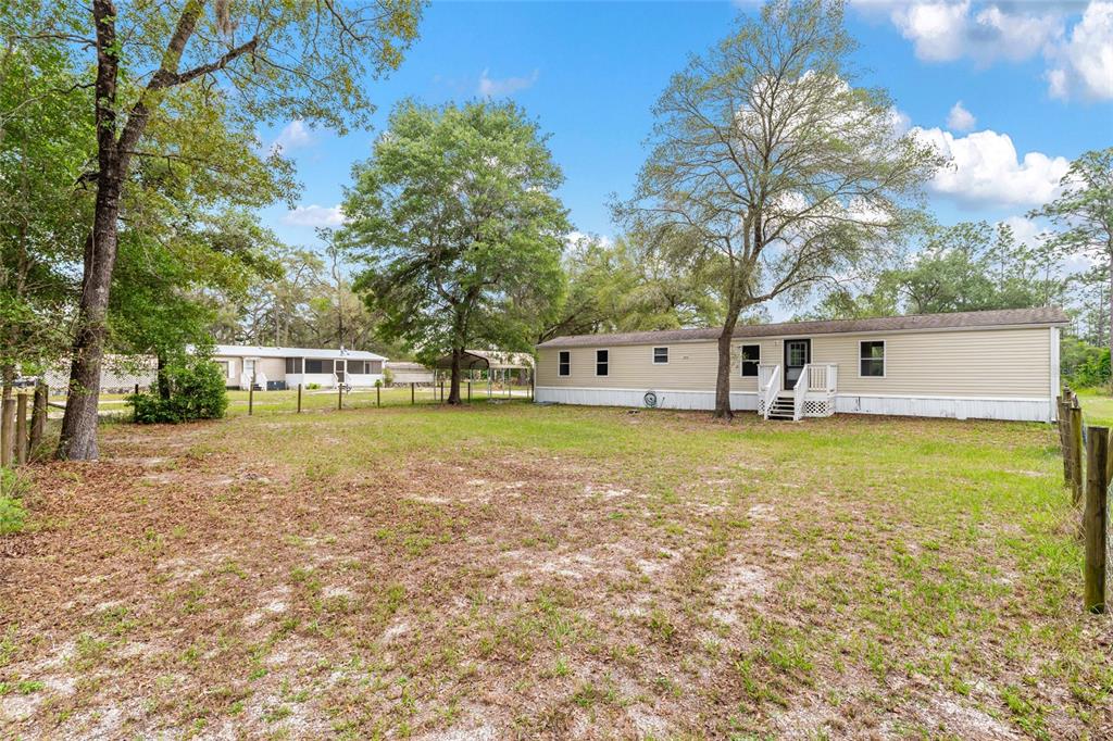 8535 Southwest 155th Street Dunnellon, FL 34432 - Photo 6 of 35 a view of a house with a yard and sitting area