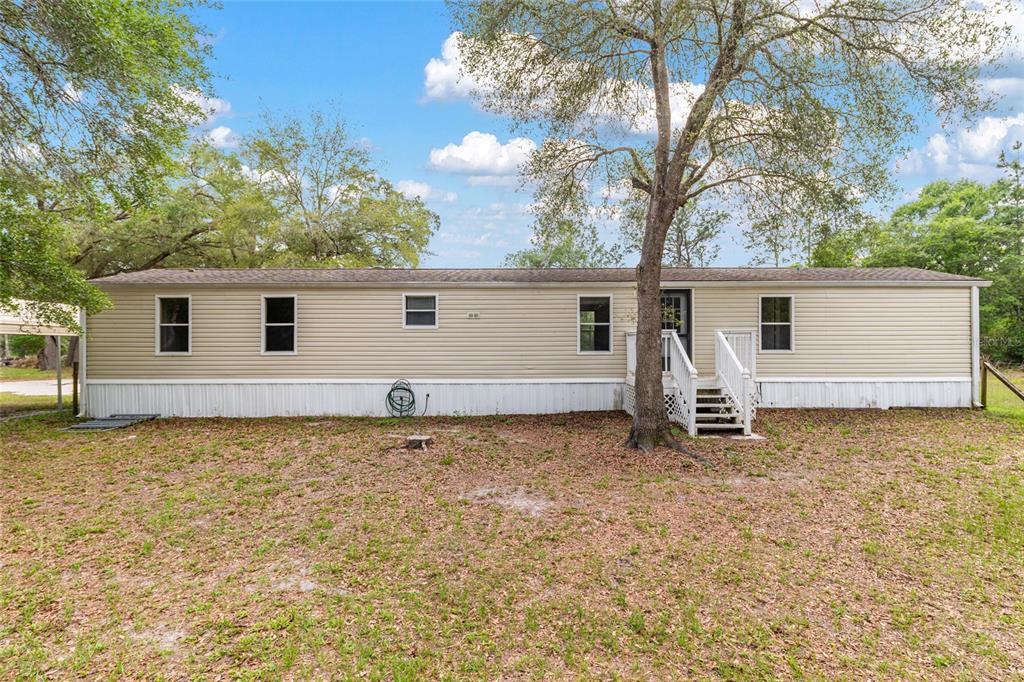 8535 Southwest 155th Street Dunnellon, FL 34432 - Photo 7 of 35 a backyard of a house with table and chairs