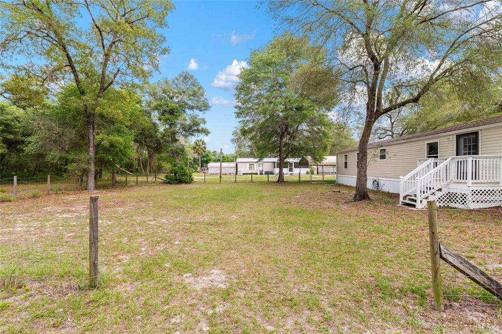 8535 Southwest 155th Street Dunnellon, FL 34432 - Photo 8 of 35 a view of back yard of the house with a patio