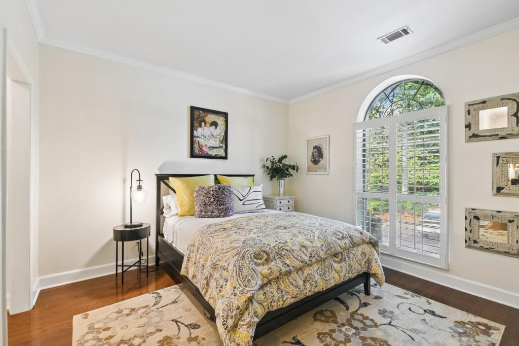2921 Lenox Road Northeast, Unit 103 Atlanta, GA 30324 - Photo 26 of 37 a bedroom with a large bed and a window