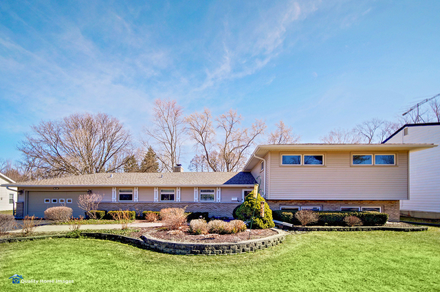 2007 Driving Park Road Wheaton, IL 60187 - Photo 1 of 29 a front view of house with yard outdoor seating and green space