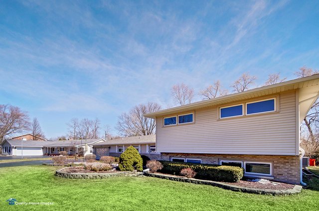 2007 Driving Park Road Wheaton, IL 60187 - Photo 2 of 29 a front view of house with yard and outdoor seating