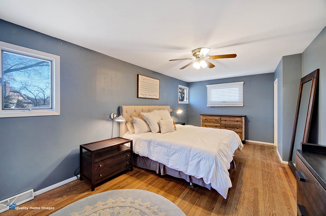 2007 Driving Park Road Wheaton, IL 60187 - Photo 16 of 29 a bedroom with a bed and a chandelier