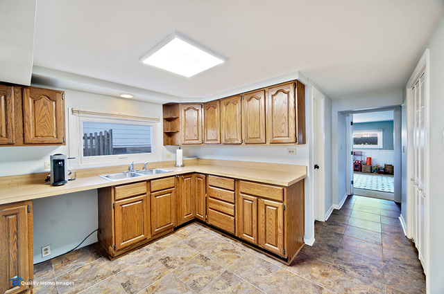 2007 Driving Park Road Wheaton, IL 60187 - Photo 24 of 29 a kitchen with a sink stove and cabinets