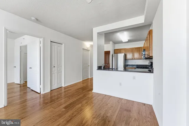a view of a hallway with wooden floor