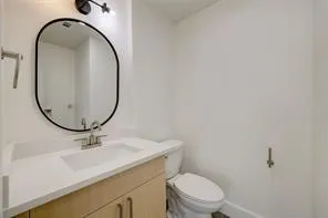 a bathroom with a sink a mirror and a toilet