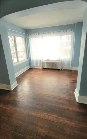 a view of a room with window and wooden floor