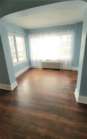 a view of a room with window and wooden floor