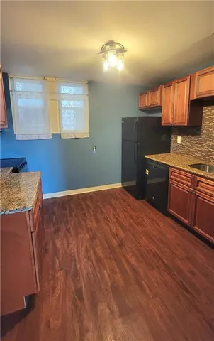 a spacious bathroom with a granite countertop sink and a mirror