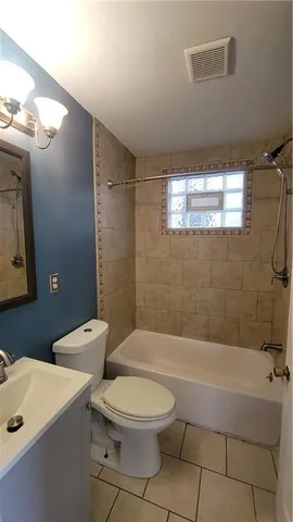 a bathroom with a toilet a sink and bathtub