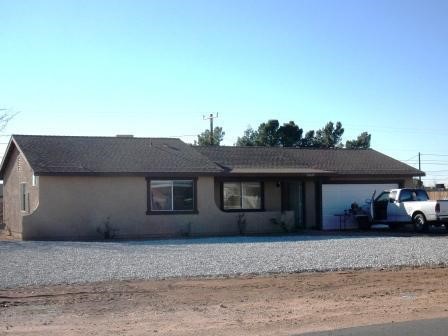 10620 Tecopa Road Apple Valley, CA 92308 - Photo 1 of 1 a front view of a house with a yard