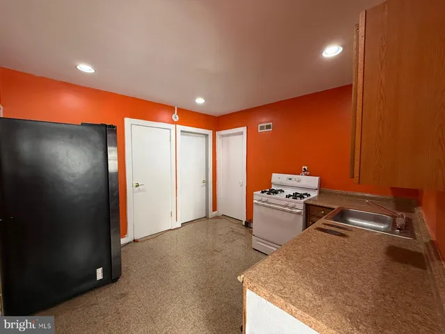 a kitchen with stainless steel appliances granite countertop a stove and a refrigerator