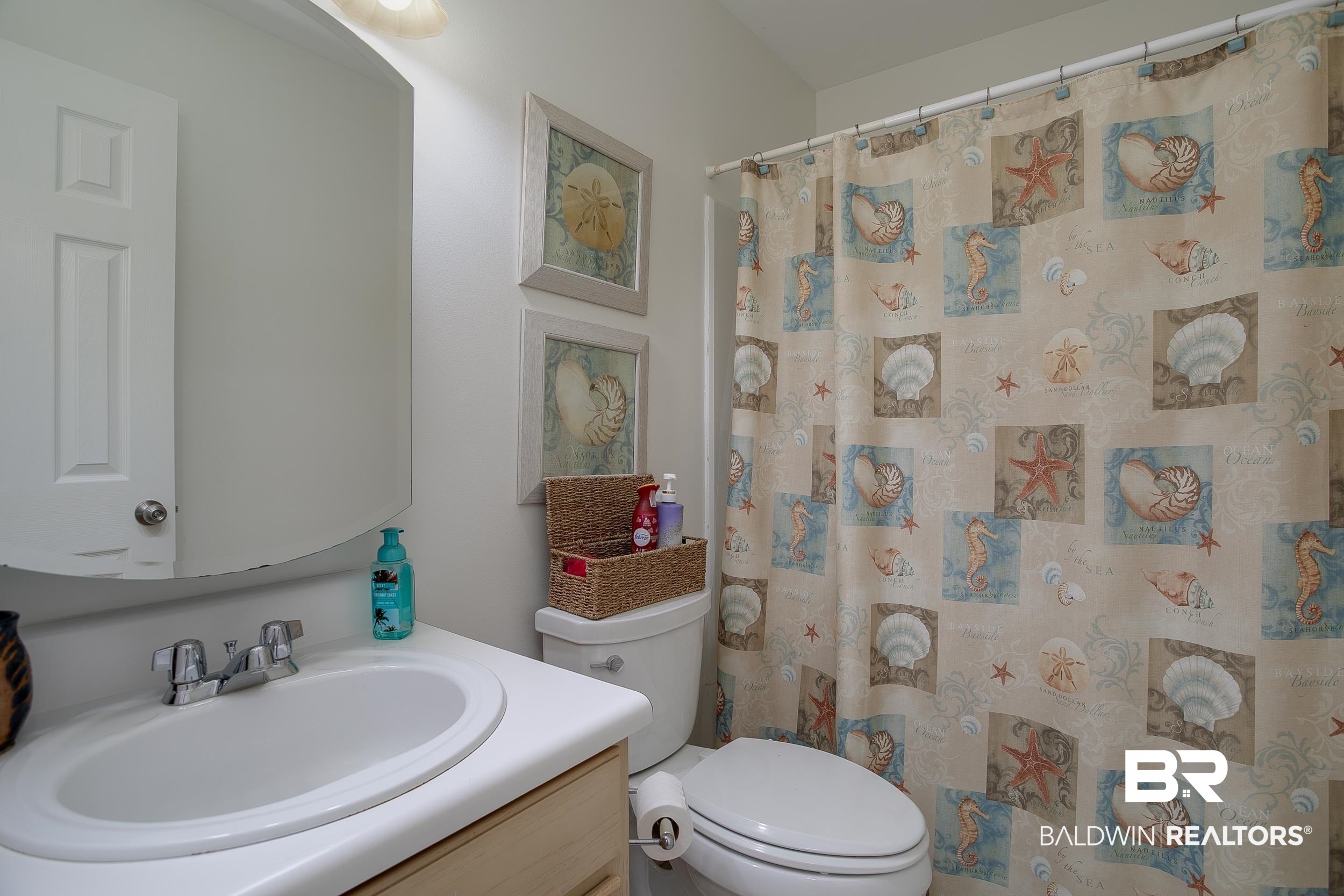 1517 Regency Road, Unit 33 Gulf Shores, AL 36542 - Photo 22 of 29 Bathroom with a shower with curtain, toilet, and vanity