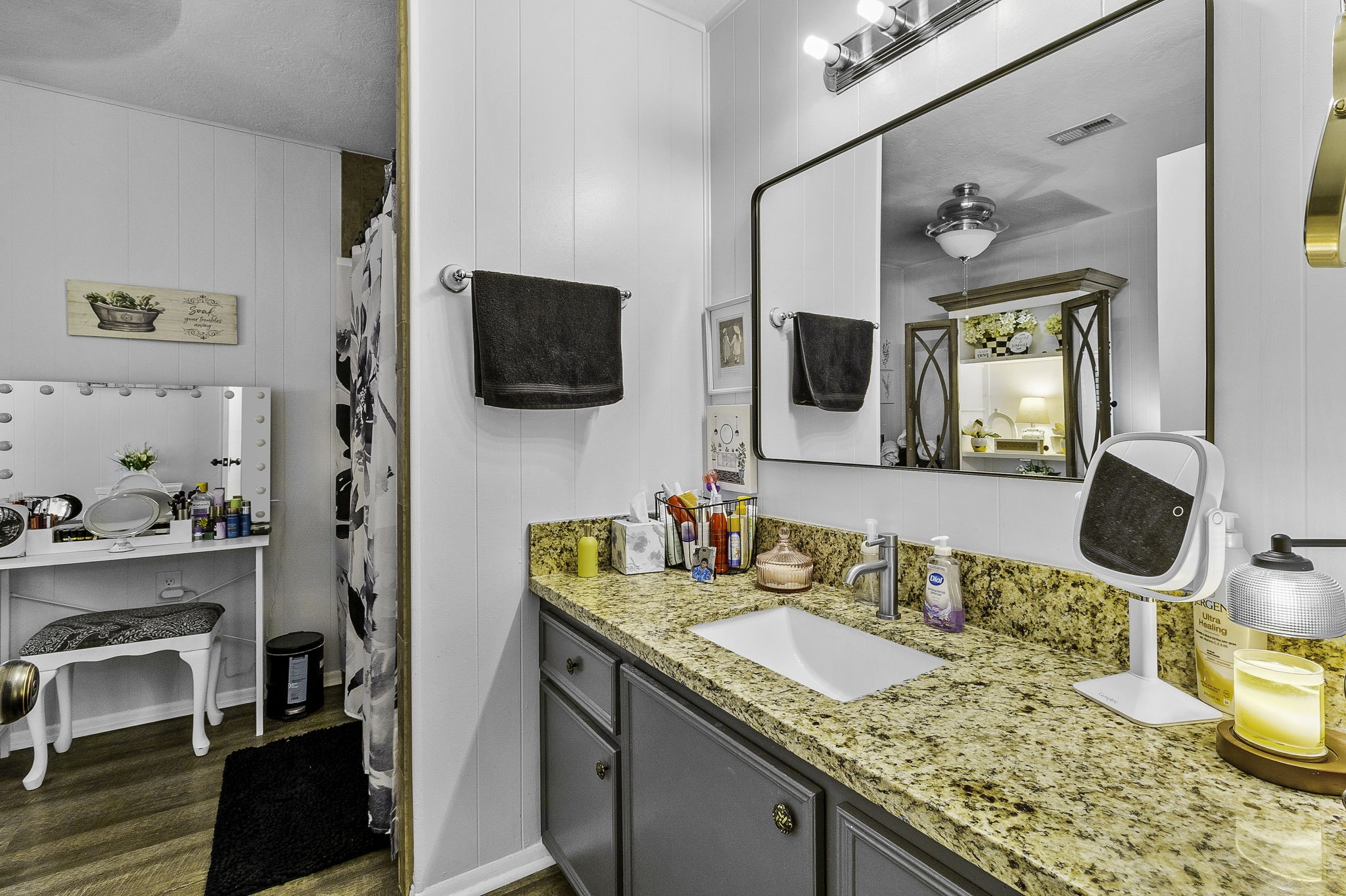 188 Huckleberry Road Onalaska, TX 77360 - Photo 18 of 49 a bathroom with a granite countertop sink a large mirror and a window