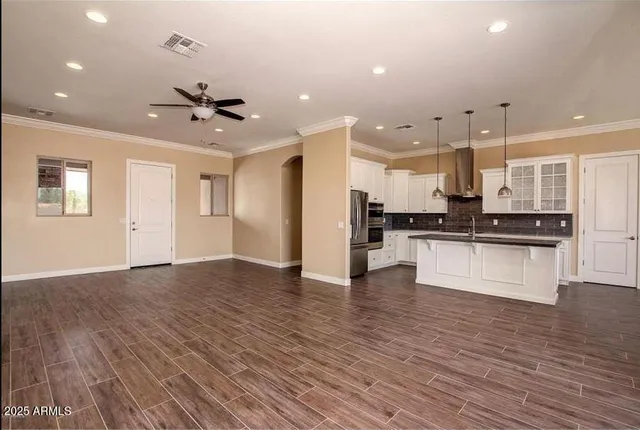 a view of kitchen with refrigerator and microwave