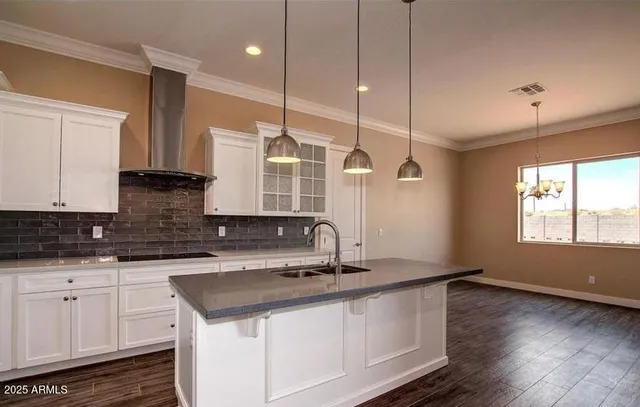 a kitchen with granite countertop a sink a counter space appliances and cabinets