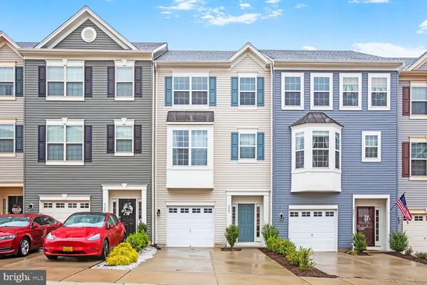 a front view of a residential apartment building with a yard