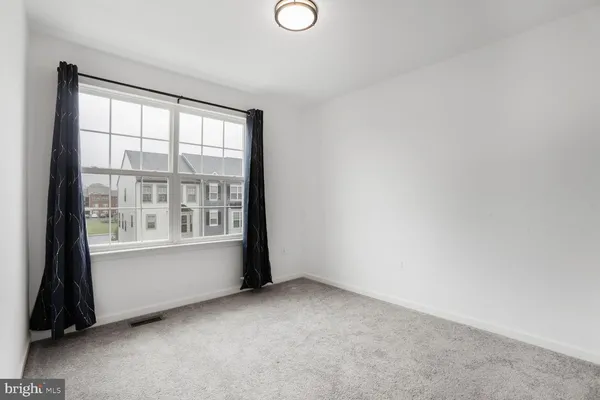 an empty room with a empty space and a window