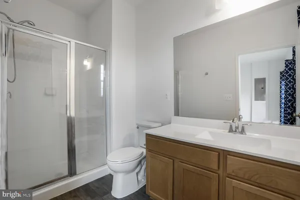 a bathroom with a sink toilet and mirror