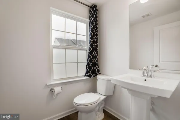 a bathroom with a sink toilet and mirror