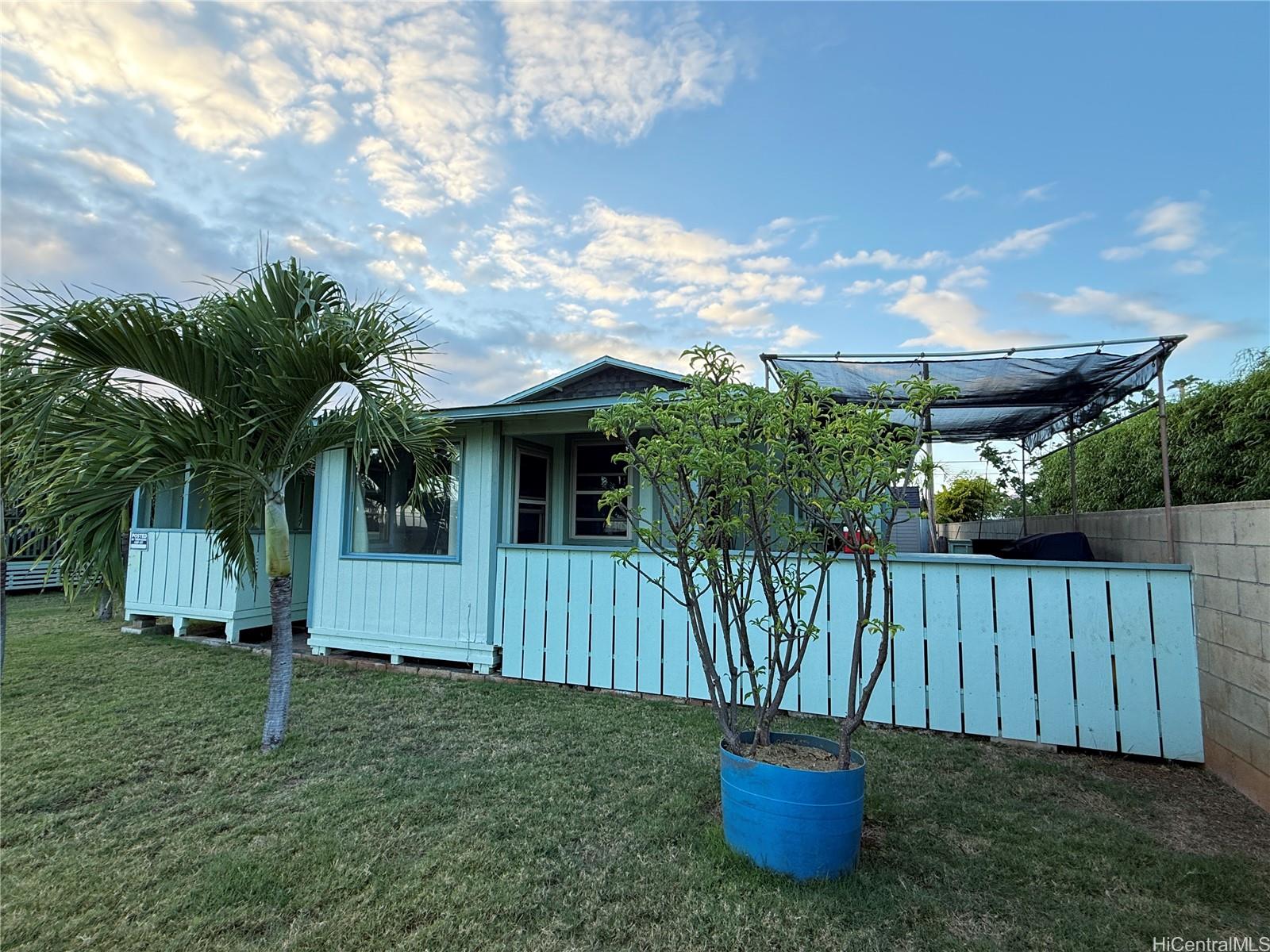 91-249 Ewa Beach Road Ewa Beach, HI 96706 - Photo 2 of 24 a view of a house with backyard and sitting area