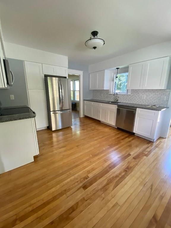64 Chilson Street Springfield, MA 01118 - Photo 11 of 36 a view of a kitchen with wooden floor and electronic appliances