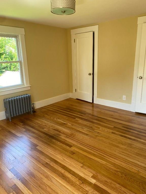 64 Chilson Street Springfield, MA 01118 - Photo 20 of 36 a view of an empty room with wooden floor and a window