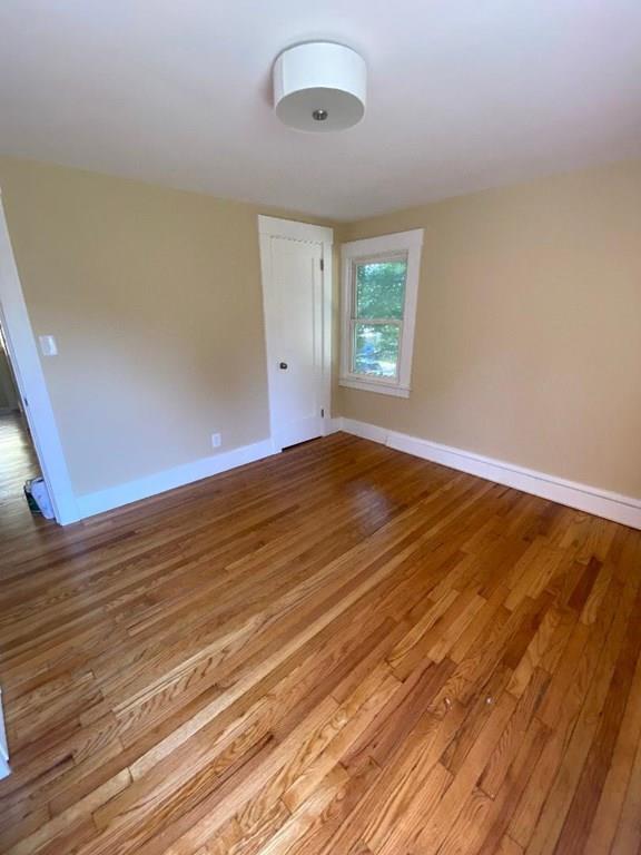 64 Chilson Street Springfield, MA 01118 - Photo 23 of 36 an empty room with wooden floor and windows