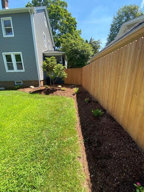 64 Chilson Street Springfield, MA 01118 - Photo 28 of 36 a view of backyard with potted plants and wooden fence